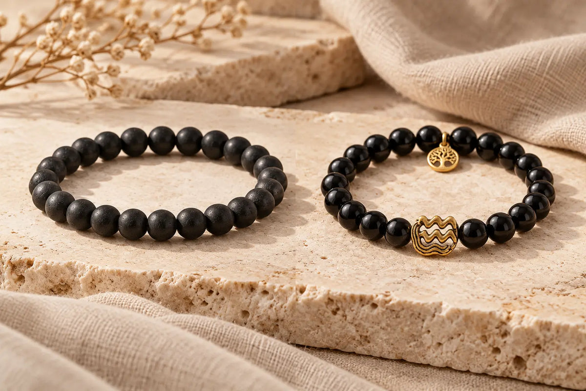 Matte Black Tourmaline and polished Black Onyx bracelets compared on warm stone