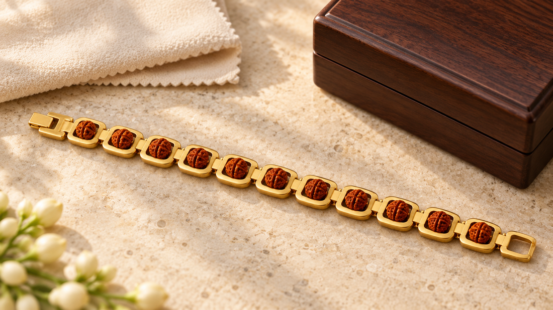 Gold-plated Rudraksha link bracelet beside a dry jewellery cloth and wooden storage box