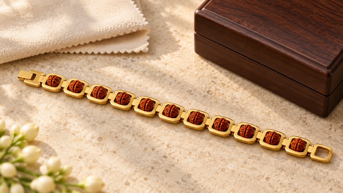 Gold-plated Rudraksha link bracelet beside a dry jewellery cloth and wooden storage box