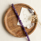 Sagittarius & Pisces Jupiter Zodiac Bracelet styled flat-lay with astrology props